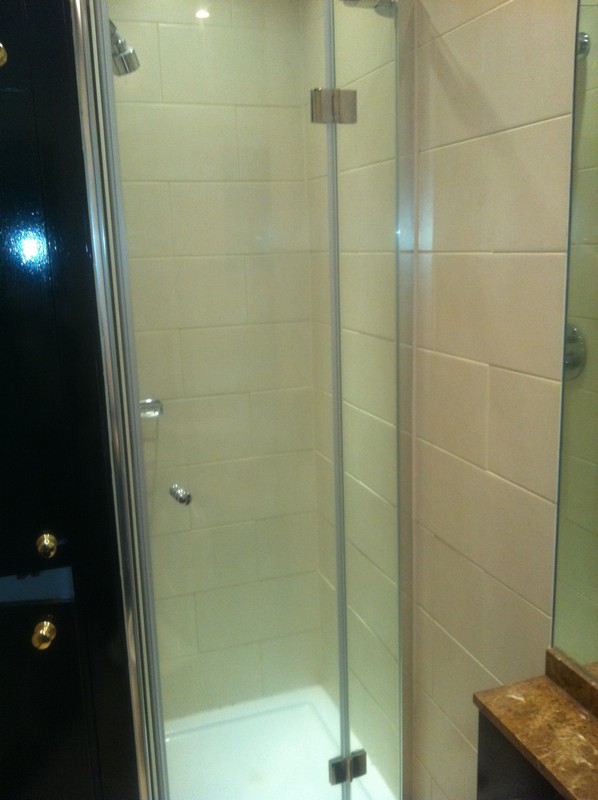 Frameless glass shower enclosure with chrome fittings in Wimbledon